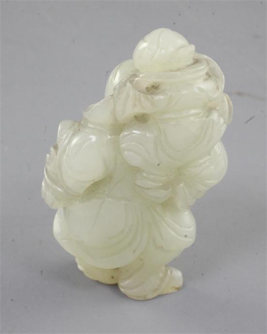 A Chinese pale celadon jade group of a sage with a boy on his back, 18th/19th century, height 5.2cm, wood stand